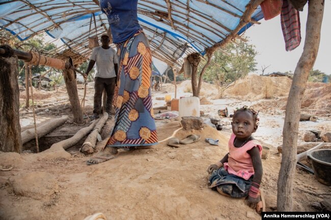 One-year-old Awa Ba plays close to a gold mining pit in Senegal's Kedougou region Nov. 16, 2022.