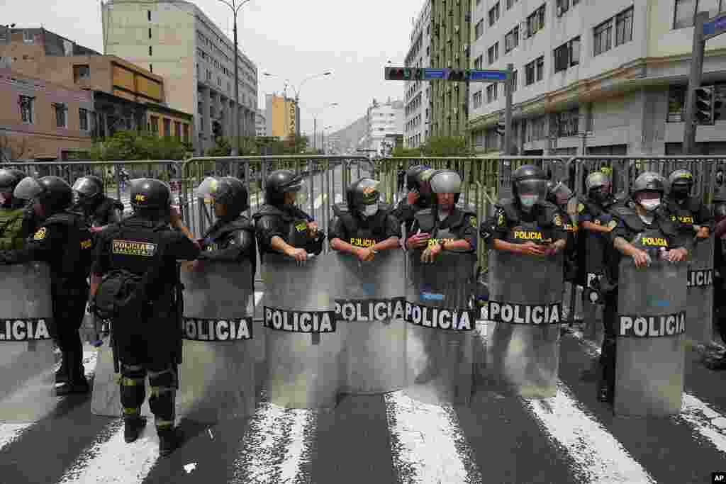 Police block a street that leads to Congress after Peruvian President Pedro Castillo dissolved the body on the day lawmakers planned an impeachment vote on him in Lima, Peru.