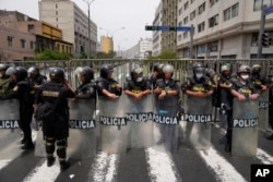Police block a street that leads to Congress after Peruvian President Pedro Castillo dissolved the body on the day lawmakers planned an impeachment vote on him in Lima, Peru, Dec. 7, 2022.