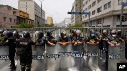 Police block a street that leads to Congress after Peruvian President Pedro Castillo dissolved the body on the day lawmakers planned an impeachment vote on him in Lima, Peru.