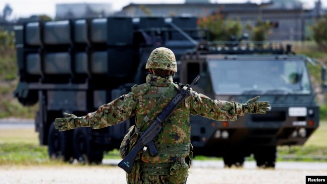 FILE - A member of the Japan Ground Self-Defense Force (JGSDF) conducts a military drill with an anti-ship missiles unit, at JGSDF Miyako camp on Miyako Island, Okinawa prefecture, Japan, Apr. 21, 2022. 