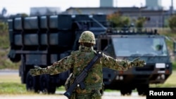 FILE - A member of the Japan Ground Self-Defense Force (JGSDF) conducts a military drill with an anti-ship missiles unit, at JGSDF Miyako camp on Miyako Island, Okinawa prefecture, Japan, Apr. 21, 2022. 