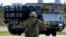 FILE - A member of the Japan Ground Self-Defense Force (JGSDF) conducts a military drill with an anti-ship missiles unit, at JGSDF Miyako camp on Miyako Island, Okinawa prefecture, Japan, Apr. 21, 2022. 