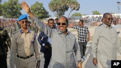 FILE - Hassan Sheikh Mohamud, the president of Somalia, leads a demonstration at Banadir Stadium, Mogadishu, Jan. 12, 2023. The president announced Friday that his government has banned people from carrying weapons on the streets of Mogadishu, the country's capital.