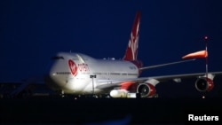 Cosmic Girl, a Virgin Boeing 747-400 aircraft, sits on the tarmac with Virgin Orbit's LauncherOne rocket attached to the wing, ahead of the first U.K. launch, at Spaceport Cornwall at Newquay Airport in Newquay, Britain, Jan. 9, 2023. 