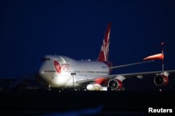 Cosmic Girl, a Virgin Boeing 747-400 aircraft, sits on the tarmac with Virgin Orbit's LauncherOne rocket attached to the wing, ahead of the first launch, at Spaceport Cornwall at Newquay Airport in Newquay, Britain, Jan. 9, 2023.
