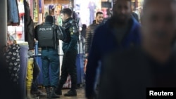  FILE - Police officers stand in Tehran Bazaar, in Tehran, Iran, Dec. 5, 2022. Several Iranian top-tier football players were reportedly briefly detained at a party on New Year's Eve where alcohol was served in violation of an Islamic ban. (Majid Asgaripour/WANA via Reuters)