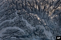 A glacier is seen from Garrett Fisher's plane in Norway, on July 29, 2022. (AP Photo/Bram Janssen)