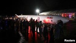 Spectators gather around a replica rocket at Cornwall Airport Newquay to watch the first ever UK launch of Virgin Orbit's LauncherOne rocket from Spaceport Cornwall in Newquay, Britain, Jan. 9, 2023. 