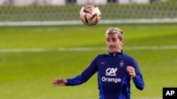 France's Antoine Griezmann heads the ball during the training session at the Jassim Bin Hamad stadium in Doha, Qatar, Dec. 16, 2022. France will play against Argentina during the World Cup final soccer match on Dec. 18, 2022.