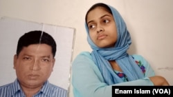 Anisha Islam Insha with the photo of her father Ismail Hossain Baten, an enforced disappearance victim. Mr Baten remains has not been seen since members of a government security agency picked him up from Dhaka in 2019. "We are anxiously waiting for the safe return of my father," the daughter said.