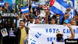 FILE - Nicaraguans exiled in Costa Rica march in a protest against Nicaragua's municipal elections, in San Jose, Costa Rica, Nov. 6, 2022.