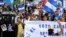 FILE - Nicaraguans exiled in Costa Rica march in a protest against Nicaragua's municipal elections, in San Jose, Costa Rica, Nov. 6, 2022.
