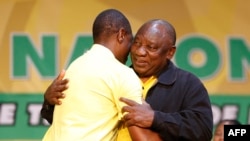South African President and re-elected leader of the African National Congress (ANC) Cyril Ramaphosa (R) congratulates newly elected Deputy leader of the ANC Paul Mashatile (L) during the 55th National Conference of the ANC in Johannesburg, Dec. 19, 2022.