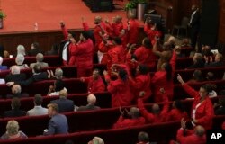 Members of the Economic Freedom Fighters cheer for a vote to impeach President Cyril Ramaphosa at a special sitting of parliament in Cape Town, South Africa, Dec. 13, 2022.