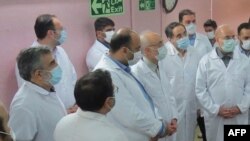 FILE - A handout picture provided by Iran's Atomic Energy Organization shows Iranian Parliament speaker Mohammad Bagher Ghalibaf (R) and the head of the Iranian Atomic Organization Ali Akbar Salehi (L) visiting the Fordo Uranium Conversion Facility, in Ir