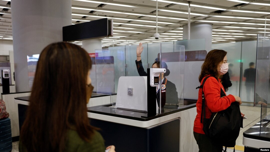 A worker checks passengers tickets at West Kowloon High-Speed Train Station Terminus on the first day of the resumption of rail service to mainland China, during the coronavirus disease (COVID-19) pandemic in Hong Kong, China, Jan. 15, 2023. 