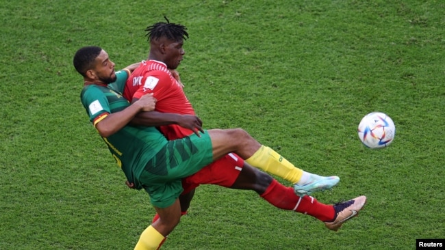 Switzerland's Breel Embolo fights for the ball with Cameroon's Jean-Charles Castelletto during the World Cup group G soccer match at the Al Janoub Stadium in Al Wakrah, Qatar, Nov. 24, 2022.