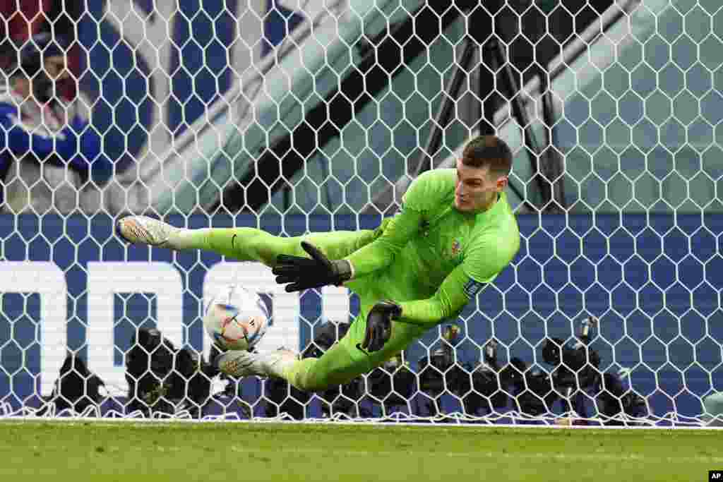 Croatia&#39;s goalkeeper Dominik Livakovic makes a save during the penalties shootout during the World Cup round of 16 soccer match between Japan and Croatia at the Al Janoub Stadium in Al Wakrah, Qatar.&nbsp;Croatia won a penalty shootout 3-1 to qualify for the next round.