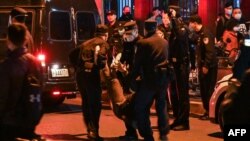 A man is arrested while people gathering on a street in Shanghai on Nov. 27, 2022, where protests against China's zero-COVID policy took place the night before following a deadly fire in Urumqi, the capital of the Xinjiang region. 