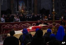 The body of late Pope Emeritus Benedict XVI is lied out in state inside St. Peter's Basilica at The Vatican where thousands went to pay their homage, Jan. 2, 2023.