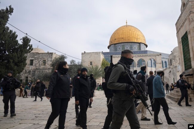 Polisi Israel mengawal pengunjung Yahudi ke kompleks Masjid Al-Aqsa, yang dikenal oleh umat Islam sebagai Tempat Suci Mulia dan bagi orang Yahudi sebagai Temple Mount, di Kota Tua Yerusalem, 3 Januari 2023.