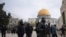 Israeli police escort Jewish visitors to the Al-Aqsa Mosque compound, known to Muslims as the Noble Sanctuary and to Jews as the Temple Mount, in the Old City of Jerusalem, Jan. 3, 2023.