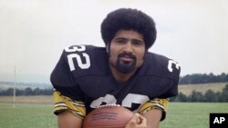 FILE - Pittsburgh Steelers running back Franco Harris is shown in 1973. Harris, the Hall of Fame running back whose heads-up thinking authored 'The Immaculate Reception,' is considered the most iconic play in NFL history. 