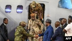 Ivorian President Alassane Ouattara greets the 46 Ivorian soldiers who were arrested in July and condemned by the Malian courts and pardoned, upon arrival at Abidjan airport on Jan. 7, 2023. 