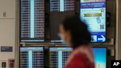 Cancelled Southwest Airlines flights are seen in red on the flight schedules at the Southwest terminal at Los Angeles International Airport, in Los Angeles, California, Dec. 27, 2022.