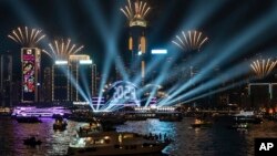 Fireworks are seen over Victoria Harbour at midnight on New Years Sunday Jan. 1, 2023 in Hong Kong. (AP Photo/Anthony Kwan)