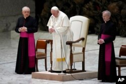 Pope Francis, center, attends the weekly general audience in the Paul VI Hall at the Vatican, Dec. 28, 2022.