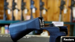 FILE - A bump stock that attaches to a semiautomatic rifle to increase the firing rate is seen at Good Guys Gun Shop in Orem, Utah, Oct. 4, 2017. 