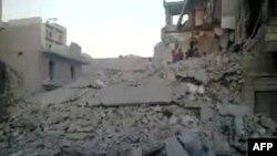 An image grab taken from a video uploaded on YouTube on September 24, 2012 allegedly shows a destroyed building in which three children from one family died following a strike by Syrian regime warplanes in Aleppo.