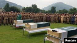 Army soldiers and civilians attend the funeral of three soldiers who, according to Pakistan Army, were killed in a cross-border exchange of fire on the Line of Control, at army stadium in Muzaffarabad, Pakistan-administrated Kashmir, Aug. 16, 2019. 