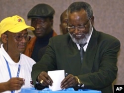 FILE - Namibian President Sam Nujoma, right, casts his vote as an unidentified election worker looks on during the Day 1 of the 2004 elections in Windhoek, Namibia, Nov. 15, 2004.