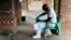 A health care worker wears virus protective gear at a treatment center in Bikoro, Democratic Republic of Congo, May 13, 2018. Congo's latest Ebola outbreak has spread to a city of more than 1 million people, a worrying shift as the deadly virus risks traveling more easily in densely populated areas. 