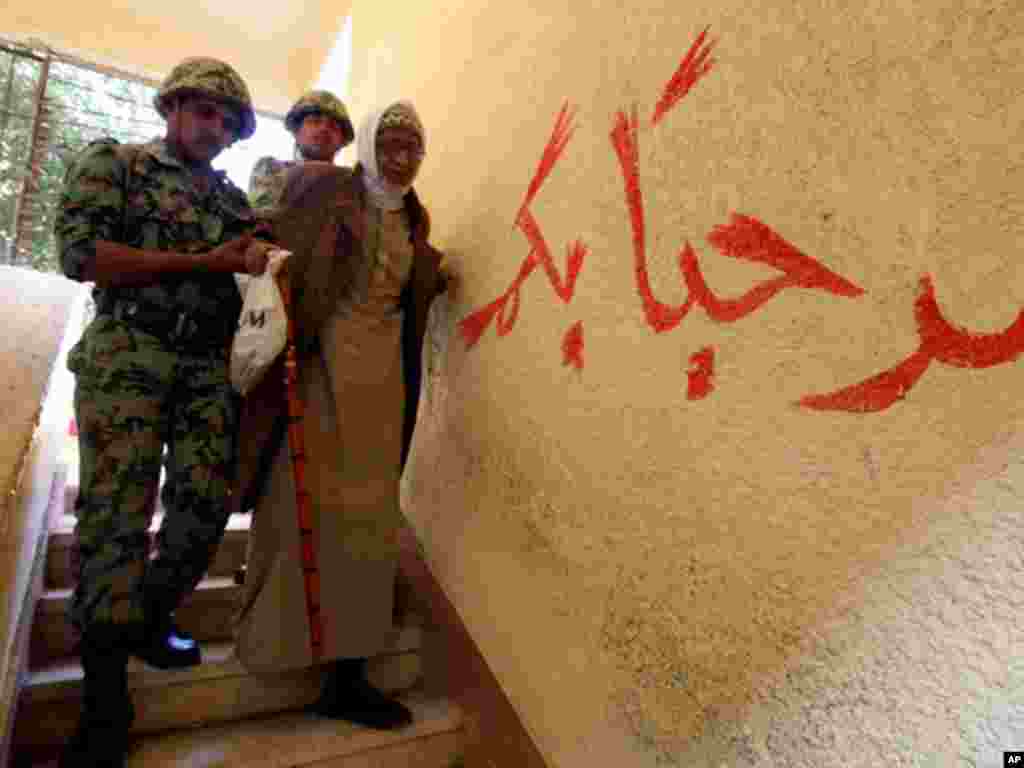 A man is helped by army soldiers after casting his vote at Shubra in El-Kalubia, on the outskirts of Cairo. (Reuters)
