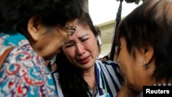 Relatives of passengers onboard AirAsia flight QZ8501 cry in a waiting area at Juanda International Airport in Surabaya December 29, 2014. A missing AirAsia jet carrying 162 people could be at the bottom of the sea after it was presumed to have crashed of