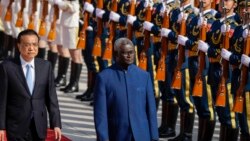 In this file photo, Chinese Premier Li Keqiang, left, and Solomon Islands Prime Minister Manasseh Sogavare review an honor guard during a welcome ceremony at the Great Hall of the People in Beijing, Wednesday, Oct. 9, 2019. (AP Photo/Mark Schiefelbein, Fi