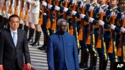 In this file photo, Chinese Premier Li Keqiang, left, and Solomon Islands Prime Minister Manasseh Sogavare review an honor guard during a welcome ceremony at the Great Hall of the People in Beijing, Wednesday, Oct. 9, 2019. (AP Photo/Mark Schiefelbein, Fi