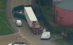 An aerial view as police forensic officers attend the scene after a truck was found to contain a large number of dead bodies, in Thurrock, South England, Oct. 23, 2019.