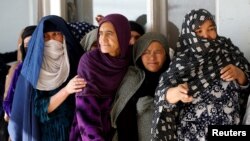 Afghan women line up to cast their votes during a parliamentary election at a polling station in Kabul, Afghanistan, Oct. 21, 2018. 