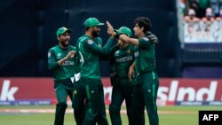 Pakistan teammates celebrate after the dismissal of India's Virat Kohli during the ICC men's Twenty20 World Cup 2024 group A cricket match between India and Pakistan at Nassau County International Cricket Stadium in East Meadow, New York on June 9, 2024.