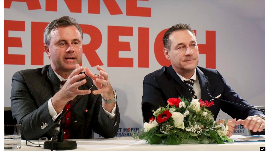 FILE - Norbert Hofer, left, and Heinz-Christian Strache of Austria's anti-migrant and anti-EU Freedom Party attend a news conference in Vienna, Austria, Dec. 6, 2016.