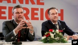 FILE - Norbert Hofer, left, and Heinz-Christian Strache of Austria's anti-migrant and anti-EU Freedom Party attend a news conference in Vienna, Austria, Dec. 6, 2016.