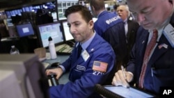 Traders work on the floor at the New York Stock Exchange in New York, January 2, 2013.