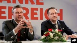 FILE - Norbert Hofer, left, and Heinz-Christian Strache of Austria's anti-migrant and anti-EU Freedom Party attend a news conference in Vienna, Dec. 6, 2016.