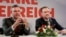 FILE - Norbert Hofer, left, and Heinz-Christian Strache of Austria's anti-migrant and anti-EU Freedom Party attend a news conference in Vienna, Dec. 6, 2016.