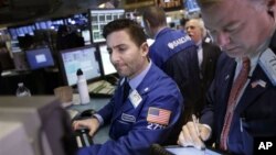 Traders work on the floor at the New York Stock Exchange in New York, January 2, 2013.